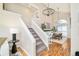 Staircase and view of open floor plan with dining room, chandelier, and sliding glass door at 19595 Mitchell Dr, Denver, CO 80249