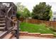 Backyard patio and a landscaped lawn with a wooden privacy fence at 10218 Woodrose Ct, Highlands Ranch, CO 80129