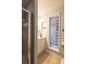 Bright bathroom showcasing a glass block window, a vanity, and a glass-enclosed shower at 10218 Woodrose Ct, Highlands Ranch, CO 80129