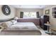 Bedroom with striped bedding, bedside table, and view of the backyard at 10218 Woodrose Ct, Highlands Ranch, CO 80129