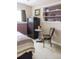 Cozy bedroom featuring a closet, a small table with flowers, and a chair near a window at 10218 Woodrose Ct, Highlands Ranch, CO 80129