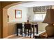 Dining area with wainscoting, wood table, and four leather chairs at 10218 Woodrose Ct, Highlands Ranch, CO 80129
