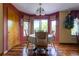 Cozy dining room featuring a round table with a large window and hardwood flooring at 10218 Woodrose Ct, Highlands Ranch, CO 80129