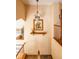 Well-lit hallway with wooden banister, decorative light fixture, and eye-catching wall art at 10218 Woodrose Ct, Highlands Ranch, CO 80129