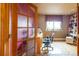 Dedicated office space with hardwood floors, glass door, and built in shelves at 10218 Woodrose Ct, Highlands Ranch, CO 80129