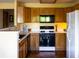 Functional kitchen with modern appliances, light wood cabinets, and hardwood floors at 10218 Woodrose Ct, Highlands Ranch, CO 80129