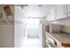 Traditional laundry room features wallpaper, a window, storage, and a washer and dryer at 10218 Woodrose Ct, Highlands Ranch, CO 80129