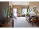 Comfortable living room with a sofa, front door view, and an array of plants filling the space at 10218 Woodrose Ct, Highlands Ranch, CO 80129