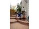 Inviting brick patio with steps leads to an upper area with river rock, plants, and a chiminea at 10218 Woodrose Ct, Highlands Ranch, CO 80129