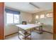 Sewing room with carpet floors, sewing machine, and large table at 10218 Woodrose Ct, Highlands Ranch, CO 80129