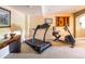 Workout room with treadmill, stationary bike, and accent furniture at 10218 Woodrose Ct, Highlands Ranch, CO 80129