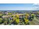 Aerial view showcasing the community near a pond with city views, mature trees, and beautiful landscaping at 119 Ward Ct, Lakewood, CO 80228