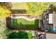 Aerial view of backyard featuring mature trees, a manicured lawn, garden boxes, and patio area at 119 Ward Ct, Lakewood, CO 80228