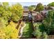 Aerial view of backyard featuring mature trees, manicured lawn, garden boxes, and outdoor living spaces at 119 Ward Ct, Lakewood, CO 80228