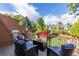 Relaxing back deck with outdoor seating, grill, and manicured lawn at 119 Ward Ct, Lakewood, CO 80228