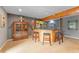 Basement bar with wood bar and cabinets, with seating for three people at 119 Ward Ct, Lakewood, CO 80228