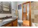 Well-appointed bathroom with granite countertop and a view to the staircase at 119 Ward Ct, Lakewood, CO 80228