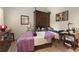 Bedroom with massage table, dark wooden furniture, and calming decor at 119 Ward Ct, Lakewood, CO 80228