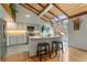 Bright kitchen featuring a skylight, modern countertops, an island with bar seating, and stainless steel appliances at 119 Ward Ct, Lakewood, CO 80228