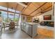 Open kitchen and living area featuring a stainless farmhouse sink and view to the fireplace and living room at 119 Ward Ct, Lakewood, CO 80228