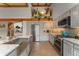 Modern kitchen featuring gray cabinets, granite countertops, stainless steel appliances, and a tiled backsplash at 119 Ward Ct, Lakewood, CO 80228