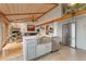 Kitchen featuring stainless steel appliances, an island with a farmhouse sink and view to the adjacent living room at 119 Ward Ct, Lakewood, CO 80228