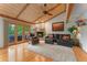 Cozy living room with vaulted ceiling, fireplace, and access to the outdoor deck at 119 Ward Ct, Lakewood, CO 80228