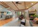 Open-concept living room with vaulted ceiling, fireplace, and barstool seating at the counter at 119 Ward Ct, Lakewood, CO 80228