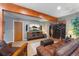 Cozy basement living room with a leather couch, wood trim, and an entertainment center at 119 Ward Ct, Lakewood, CO 80228