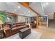 Basement living room with a leather couch, bar, and exposed wood beams at 119 Ward Ct, Lakewood, CO 80228