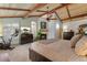 Bedroom with vaulted ceiling, fireplace, tv, arched window, and warm neutral decor at 119 Ward Ct, Lakewood, CO 80228