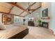 Bedroom with vaulted ceiling, fireplace, tv, arched window, and warm neutral decor at 119 Ward Ct, Lakewood, CO 80228