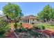 Backyard featuring a garden, lush grass and a charming single-story home at 1844 S Pontiac Way, Denver, CO 80224