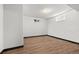 Finished basement with wood-look flooring, neutral walls and a small window at 1844 S Pontiac Way, Denver, CO 80224
