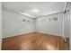 Spacious bedroom with hardwood floors and two windows providing ample natural light at 1844 S Pontiac Way, Denver, CO 80224