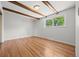 Bedroom featuring hardwood floors, exposed ceiling beams, and a window at 1844 S Pontiac Way, Denver, CO 80224