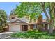 Charming two-story home with a brick facade, mature trees, and well-maintained lawn at 1844 S Pontiac Way, Denver, CO 80224