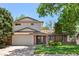 Charming two-story home with a brick facade, attached garage, and well-manicured lawn at 1844 S Pontiac Way, Denver, CO 80224