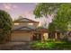 Charming two-story home boasts a brick facade, attached garage, and a well-manicured lawn at 1844 S Pontiac Way, Denver, CO 80224