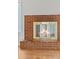 Detailed view of the brick fireplace with glass doors and wooden mantel at 1844 S Pontiac Way, Denver, CO 80224