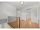 Second floor hallway with hardwood floors and access to multiple rooms at 1844 S Pontiac Way, Denver, CO 80224