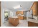Bright kitchen with tile floors, island, and sliding door to the patio at 1844 S Pontiac Way, Denver, CO 80224