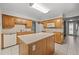 Kitchen featuring a kitchen island, tile floors, and white appliances at 1844 S Pontiac Way, Denver, CO 80224