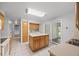 Charming kitchen with an island, tile floors, and modern appliances at 1844 S Pontiac Way, Denver, CO 80224