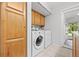 Laundry room with washer, dryer, and storage cabinets at 1844 S Pontiac Way, Denver, CO 80224