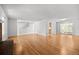 Open-concept living room with hardwood floors, staircase, and sliding glass door to backyard at 1844 S Pontiac Way, Denver, CO 80224