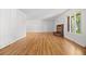 Spacious living room with hardwood floors, a cozy fireplace, and large windows at 1844 S Pontiac Way, Denver, CO 80224