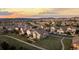 Stunning aerial view of the neighborhood at sunset, showcasing the home, streets and surrounding landscape at 1983 Candleglow St, Castle Rock, CO 80109