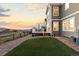 A beautiful outdoor space with an artificial lawn, patio and scenic views at sunset at 1983 Candleglow St, Castle Rock, CO 80109