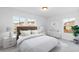 Bright bedroom featuring a plush bed, modern decor, and large windows with neighborhood views at 1983 Candleglow St, Castle Rock, CO 80109